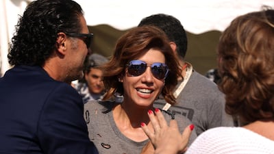 Lebanese singer Ragheb Alameh (L) welcomes Lebanese TV host Paula Yacoubian (C) during a karting race organised by Lebanese celebrities to mark the beginning of the Beirut Cultural Festival at Beirut's water front on May 20, 2016. Patrick Baz / AFP