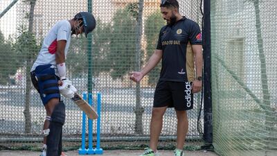 Rameez Shahzad gives tips to young UAE all-rounder Nilansh Keswani at nets at Zenith Cricket Academy.