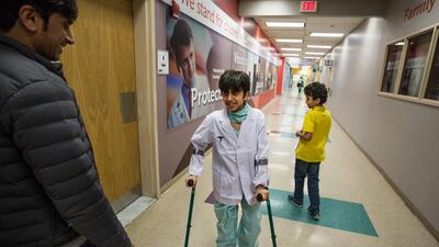 Mohamed Alaryani, 12, with his father Saif, and brother at the Sheikh Zayed Campus for Advanced Children's Medicine at Children's National Medical Centre in Washington, DC. Mohamed has Spina Bifida and has been coming from the UAE to the the Sheikh Zayed Campus for medical treatment. Launched in September 2009, the centre is redefining what is possible in surgery through an innovative, integrated research. Evelyn Hockstein for The National