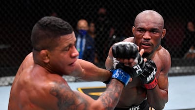 Kamaru Usman, right, of Nigeria punches Gilbert Burns of Brazil in their UFC welterweight championship fight during the UFC 258 event at UFC APEX in Las Vegas, Nevada. Jeff Bottari / Zuffa LLC / UFC