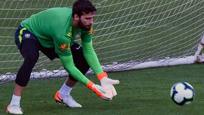 Brazil goalkeeper Alisson goes through his goalkeeping drills with the coaching staff. AFP