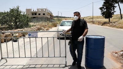 Palestinian security forces guard a checkpoint at an access road in the village of Beit Aula, north of the West Bank city of Hebron. EPA
