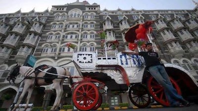 A carriage owner waits for customers outside the Taj Mahal Palace hotel in Mumbai.