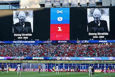 An image of Donny Strathie, the Scotland fan who died in Boston on June 14, is projected on the big screen during the match against Morocco on June 19. AFP