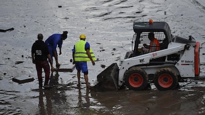 Municipal workers clear the roads after heavy rain in Kuwait City. EPA