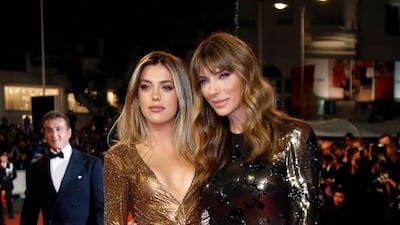 Jennifer Flavin and Sistine Stallone pose at the tribute to their husband and father, Sylvester Stallone, which was a screening of the film "Rambo : First Blood"