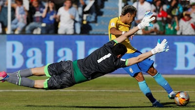 Bolivia goalkeeper Carlos Lampe at full stretch to block Neymar's effort on goal. David Mercado / Reuters
