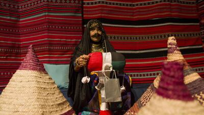 Safia Al Saadi from the General Woman's Union Handcraft Center demonstrates a tradition weaving technique at the Ramadan Nights being held at ADNEC. Antonie Robertson/The National