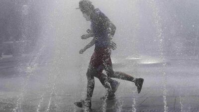 People run through the water of Stachus Fountain to cool off on a hot summer day in Munich, Germany. Ina Fassbender/Reuters