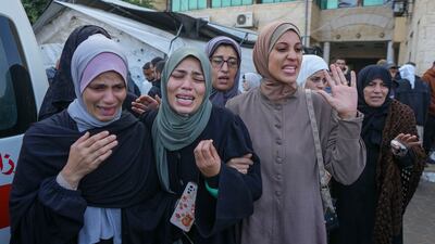 Palestinian women grieve for victims of an Israeli strike on Al Aqsa Martyrs Hospital in Gaza on Sunday. AP