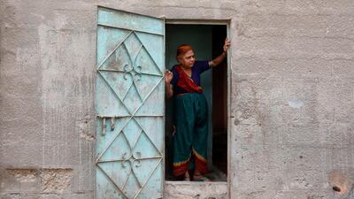 A woman stands at her door in Karachi, Pakistan. Akhtar Soomro / Reuters