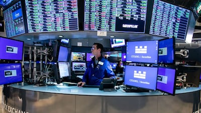 A trader works on the floor of the New York Stock Exchange. Upbeat fourth-quarter earnings will keep optimism high in US equity markets. Bloomberg