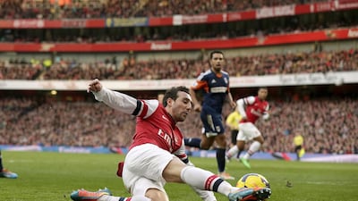 Arsenal’s Santi Cazorla slides to keep the ball in play as his side attack Fulham during a relentless second-half display by Arsene Wenger’s side. Matt Dunham / AP Photo