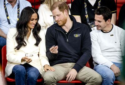 Meghan opts for an ivory belted Brandon Maxwell jacket to watch the games on Easter Sunday. AFP