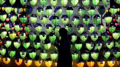 A woman prays in front of lanterns to celebrate the New Year at Jogyesa Buddhist temple in Seoul, South Korea. Ahn Young-joon / AP Photo