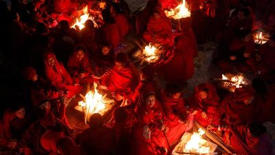 Hindu women sit around fires to keep warm before taking holy baths at Saali River during the Swasthani Brata Katha festival at Sankhu in Kathmandu, Nepal. Navesh Chitrakar / Reuters