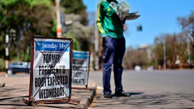 A vendor sells newspapers on the streets of Harare carrying news of the arrival of former president Robert Mugabe's body from Singapore, on Sunday, September 8, 2019. AFP