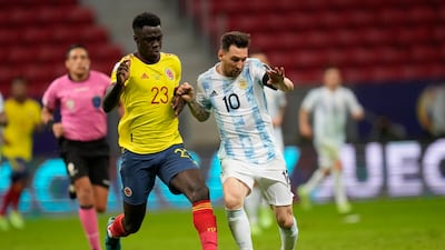 Lionel Messi, right, and Colombia's Davinson Sanchez battle for the ball.