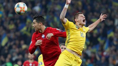 Soccer Football - Euro 2020 Qualifier - Group B - Ukraine v Portugal - NSC Olympiyskiy, Kiev, Ukraine - October 14, 2019 Ukraine's Vitaliy Mykolenko in action with Portugal's Cristiano Ronaldo REUTERS/Valentyn Ogirenko
