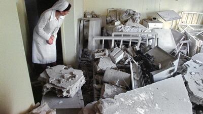 A nun inspects a damaged room in the Hotel Dieu Hospital in east Beirut on February 25, 1990, after a break in the battle between rival Christian factions. AFP