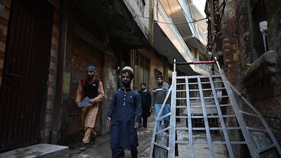 Pakistani waiter Rozi Khan walks on a street in Rawalpindi. AFP