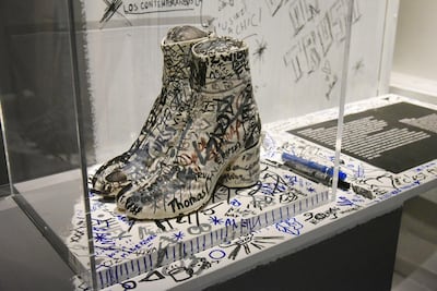 Martin Margiela’s split-toe tabi boots; right, the autumn/winter 2018 Maison Margiela runway show Getty Foc Kan/WireImage/Getty Images