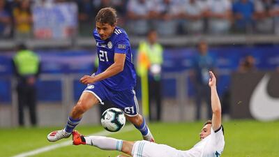 Argentina's Giovani Lo Celso, bottom, vies for the ball with Paraguay's Oscar Romero Villamayor. EPA
