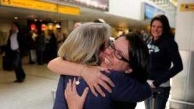 Jaqueline Wood, left, and Tara Roe Gammon embrace after returning to Heathrow from Costa Rica via Madrid yesterday.