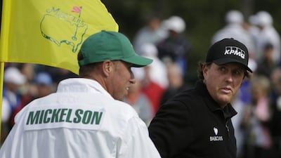 Phil Mickelson talks to his caddie Jim MacKay on the ninth hole during a practice round for the Masters golf tournament at Augusta National on Tuesday. Darron Cummings / AP / April 8, 2014