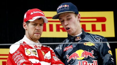 Sebastian Vettel, left, approached Daniil Kvyat, right, over his move on the first corner. Diego Azubel / EPA