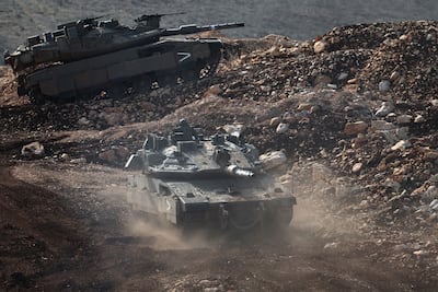 Israeli tanks patrol the Lebanese border. EPA