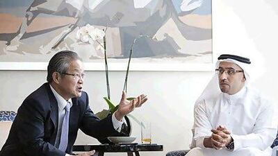 Kwon Tae-shin, the vice chairman of the Korean Presidential Council on National Competitiveness, left, with Abdullah Lootah, the secretary general of the Emirates Competitiveness Council, in Dubai yesterday. Jaime Puebla / The National