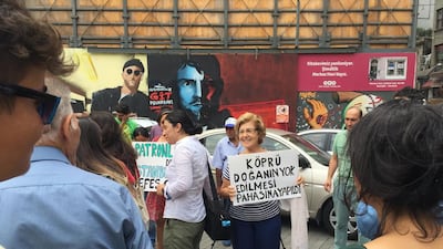 An activist holds a sign reading 'The bridge has been built at the cost of nature's destruction' during a rally in Istanbul on August 25, 2016. Paul Osterlund for The National