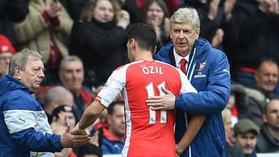 Arsenal manager Arsene Wenger shown with Mesut Ozil last Saturday during their Premier League win over Liverpool. Andy Rain / EPA / April 4, 2015