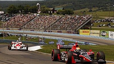 Justin Wilson leads Ryan Briscoe during the IndyCar Series at Watkins Glen in New York.