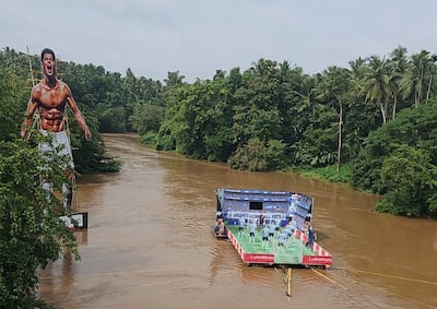 A giant poster of Cristiano Ronaldo towers over the river, near a floating platform featuring the Argentina World Cup squad, as Kerala fans celebrate the tournament. Photo: Honda Boys Pullavoor
