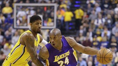 Los Angeles Lakers forward Kobe Bryant (24) drives on Indiana Pacers forward Paul George (13) during the first half of an NBA basketball game in Indianapolis, Monday, Feb. 8, 2016. (AP Photo/Michael Conroy)