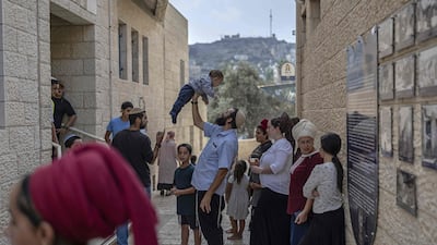Israeli settlers outside a polling station in the occupied West Bank city of Hebron. AFP