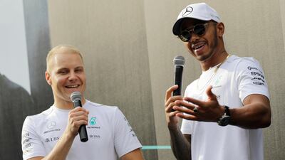 Valtteri Bottas, left, is trailing Mercedes teammate Lewis Hamilton, right, and Sebastian Vettel in the drivers' title race. Wong Maye / AP Photo