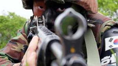 A South Korean soldier takes part in a military drill near the demilitarized zone separating South Korea from the North. The South's defence minister warned that the North could incur a military retaliation.