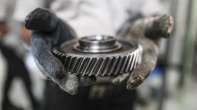 An employee holds a cleaned gear wheel at the Mahindra & Mahindra manufacturing plant in Chakan, Maharashtra, India,. Mahindra utilises solar energy for delivering dry saturated steam and pressurized hot water in cleaning and degreasing operations. Dhiraj Singh / Bloomberg