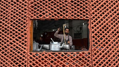 A vendor prepares tea for customers at a roadside cafe in Lahore, Pakistan. AFP