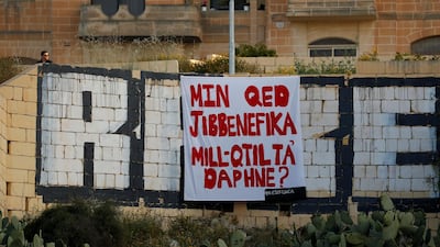A protest banner reading 'Who is benefiting from Daphne's murder?', referring to the assassination of anti-corruption journalist Daphne Caruana Galizia. REUTERS/Darrin Zammit Lupi