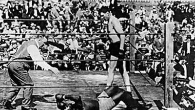 Jack Jonhson shields his eye after being "knocked out" by Jesse Willard in the 26th round in Havana back in 1915. Johnson won the title in 1908.