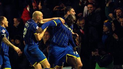 AFC Wimbledon's Adebayo Akinfenwa celebrates his goal against Liverpool in the FA Cup third round on Monday night. Sean Dempsey / EPA