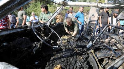 Members of the Syrian regime inspect the location where a car bomb exploded in the northeastern Syrian town of Qamishli which is mainly controlled by Kurdish forces, in the town of Qamishli, Syria. REUTERS