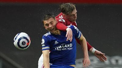 Leicester's Luke Thomas and Brandon Williams of United challenge for a header. Reuters