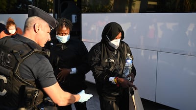 People rescued from 'Ocean Viking' rescue ship get off a bus at the 'Giens Cap Levant' holiday camp in Hyeres, southern France, where the migrants were able to stay about 20 days. AFP