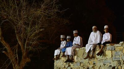 Omanis sit on a wall ahead of a marathon near Nizwa. AFP