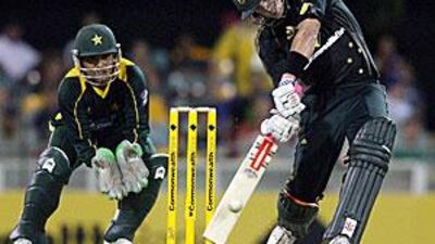 Cameron White of Australia hits the ball over the boundary for his third six in a row off Shahid Afridi's bowling.